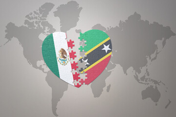 puzzle heart with the national flag of saint kitts and nevis and mexico on a world map background.Concept.
