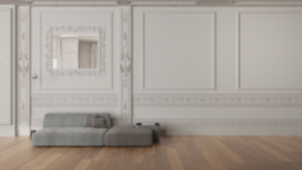 Blur background, modern furniture in classic apartment, living room, modern sofa and pouf. Parquet, plaster molded walls. Background with copy space, mock up. Interior design