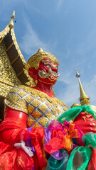 A giant red-colored statue guarding the temple.