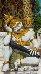 A giant statue sitting in front of the temple