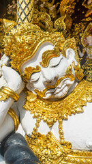 A giant statue sitting in front of the temple