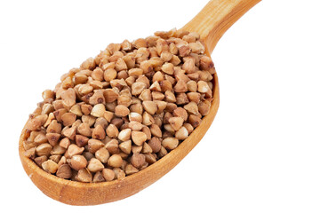 Buckwheat in a wooden spoon isolated on white. Top view.