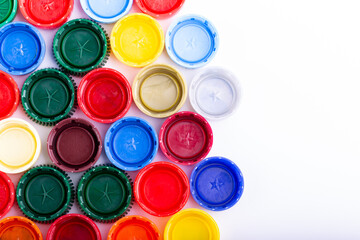 Plastic bottle caps on white background. Cap material is recyclable. Recycling collection and processing plastic bottle caps.