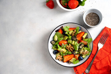 Fototapeta na wymiar Strawberry and blueberry salad, detox, healthy eating summer food.