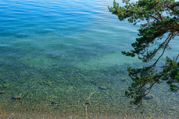 Landscape with the coast of Lake Baikal in calm clear weather .