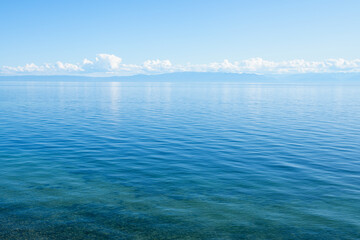 Landscape with the coast of Lake Baikal in calm clear weather .