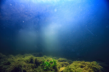 Obraz na płótnie Canvas sun rays under water blue ocean background, abstract sun light in water wallpaper