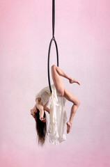 Graceful woman doing trick on aerial hoop