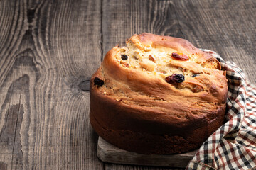 Homemade cake with raisins and nut on wooden table