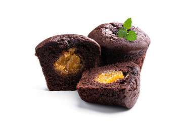 Dark chocolate muffin stuffed with yellow jam isolated on white