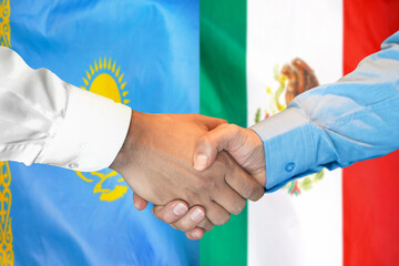 Handshake on Kazakhstan and Mexico flag background. Support concept