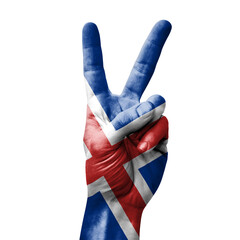 Hand making the V victory sign with flag of iceland