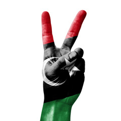 Hand making the V victory sign with flag of libya
