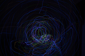Light painting Abstract colorful irregular lines or patterns on black background with long exposure.