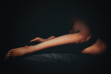 Girl in stockings against dark background - 508778408
