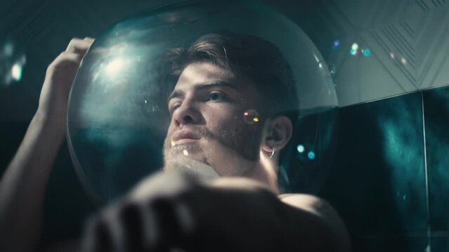  Thoughtful man alone wrapped in soap bubbles
