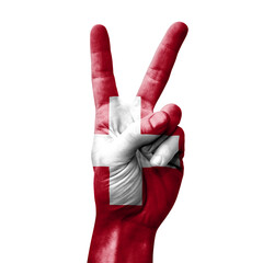 Hand making the V victory sign with flag of switzerland