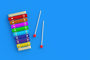 Xylophone with sticks on blue background. Kids toy. Preschool education. Musical instrument. Funny laisure. Copy space. Flat lay. 3d render