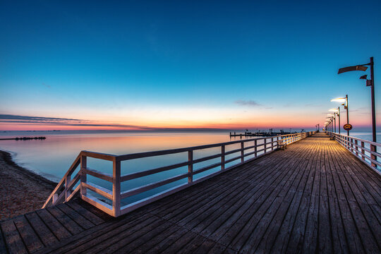 Sunrise over the pier in Mecheliki © R_Szatkowski