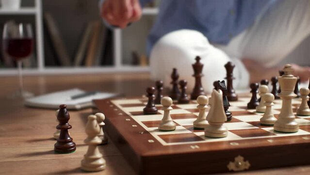 aking a move with a chess piece on a chessboard, a girl c