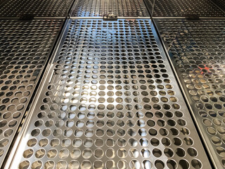 Steel perforated insert of a laboratory water bath.