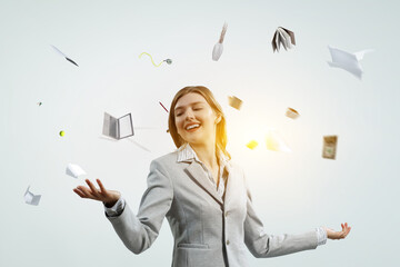 Young pretty businesswoman juggling with business items