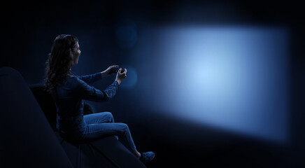 Obraz na płótnie Canvas Young woman watching movie . Mixed media