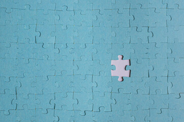 Blue puzzle with one missing peace