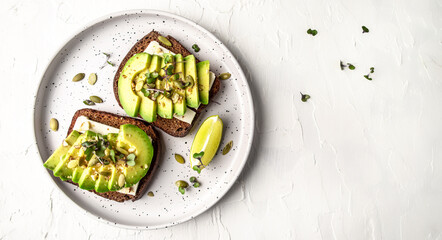 Healthy avocado toasts with rye bread, sliced avocado, cheese, pumpkin, nut and sesame for breakfast or lunch. Vegetarian food. Vegan menu. Long banner format. top view