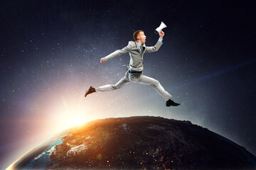 Obraz na płótnie Canvas Portrait of energetic businessman jumping in open air