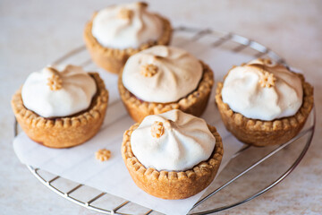 Set of lemon curd tartlets with whipped meringue. Close up.