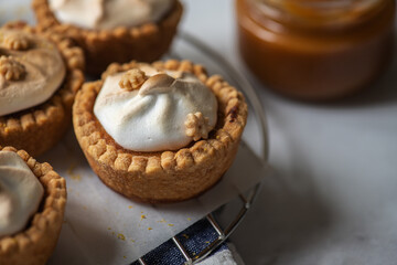 Lemon curd tartlets with whipped meringue and caramel sauce.