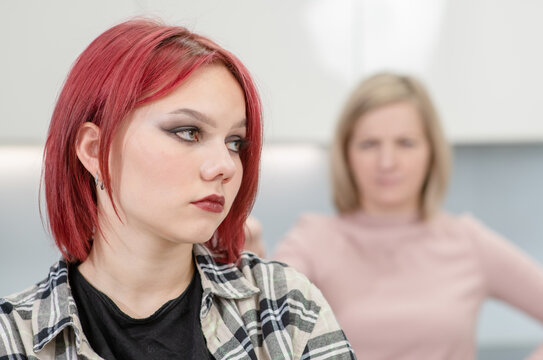Family conflict. Unhappy mother and resentful daughter are offended at each other