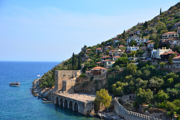 Fototapeta premium coastline with ancient fortress, typical turkish houses and green trees in summer