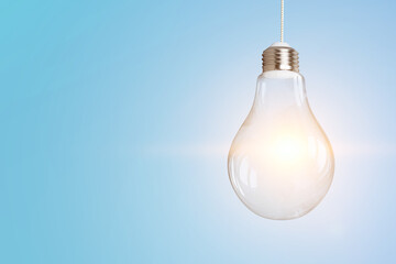 Light bulb on light blue background