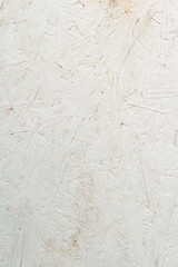 Sheet of white plywood with fragments of compressed sawdust.