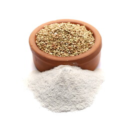 Buckwheat flour and grains in clay pot isolated on white  