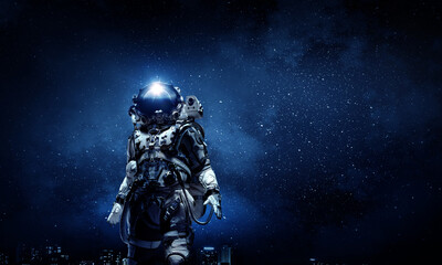 Fototapeta na wymiar Astronaut walking on an unexplored planet