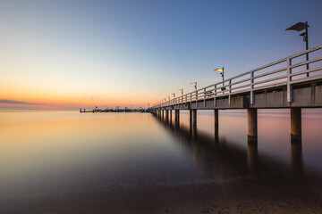 Fototapeta na wymiar Sunrise over the pier in Mechelinki.