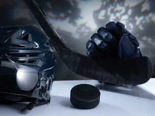 Closeup of ice hockey equipment against a dark background. Ice hockey helmet, stick, puck and gloves - obrazy, fototapety, plakaty