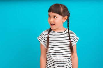 Portrait of happy excited amazed open mouth kid child girl brunette striped dress look in copyspace