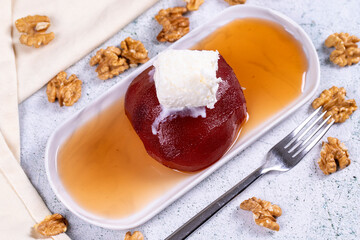Quince dessert. Traditional Turkish cuisine delicacies. Quince dessert with cream on a stone background. Close-up. local name ayva tatlisi