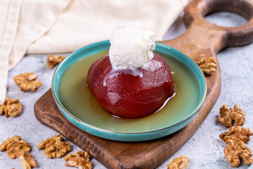 Quince dessert. Traditional Turkish cuisine delicacies. Quince dessert with cream on a stone background. Close-up. local name ayva tatlisi
