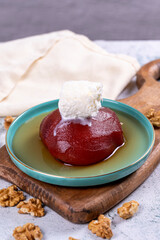 Quince dessert. Traditional Turkish cuisine delicacies. Quince dessert with cream on a stone...