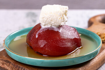 Quince dessert. Traditional Turkish cuisine delicacies. Quince dessert with cream on a stone background. Close-up. local name ayva tatlisi