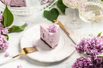a piece of mousse cake, Delicious dessert blueberry tart with fresh berries with a bouquet of purple blooming lilacs, place for text
