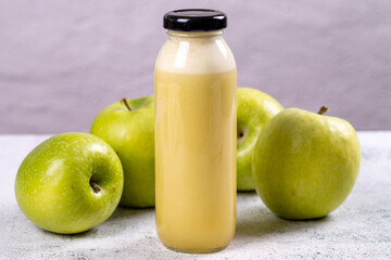 Apple juice. Freshly squeezed juice. Freshly squeezed apple juice in glass on stone background. Close-up
