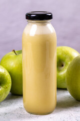 Apple juice. Freshly squeezed juice. Freshly squeezed apple juice in glass on stone background. Close-up