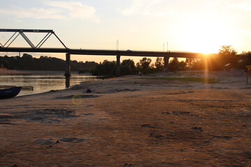 summer evening scenery on the beach overlooking the bridge at sunset. Summer holidays