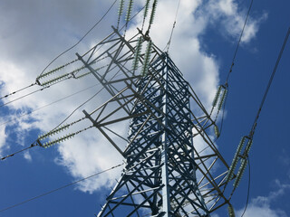 geometric design of a power line tower against a blue sky background